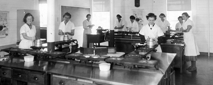 Lasell Home economics class 1936 Women cooking in a large school kitchen