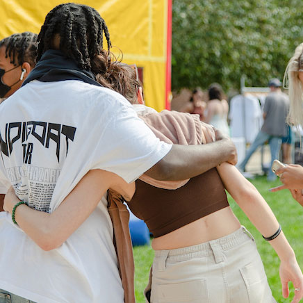 2 students friendly hug